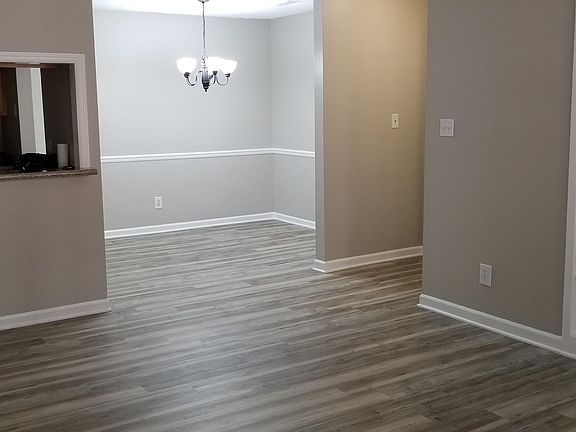 Standing in living room looking into dining space and kitchen pass through