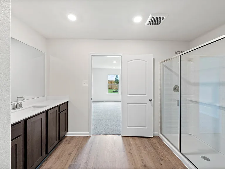 The master bathroom has a glass, walk-in shower.