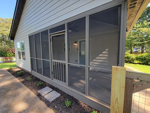 Screened-in porch with swinging doors to sidewalk and to back yard.