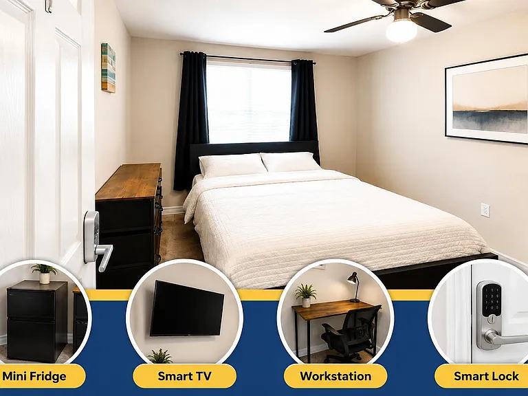 Furnished bedroom with full bed, dresser, workstation, and window with blackout curtains plus ceiling fan light.