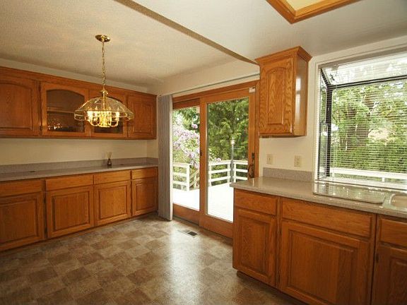 Another view of kitchen showing updated sliding wood door to outside deck.