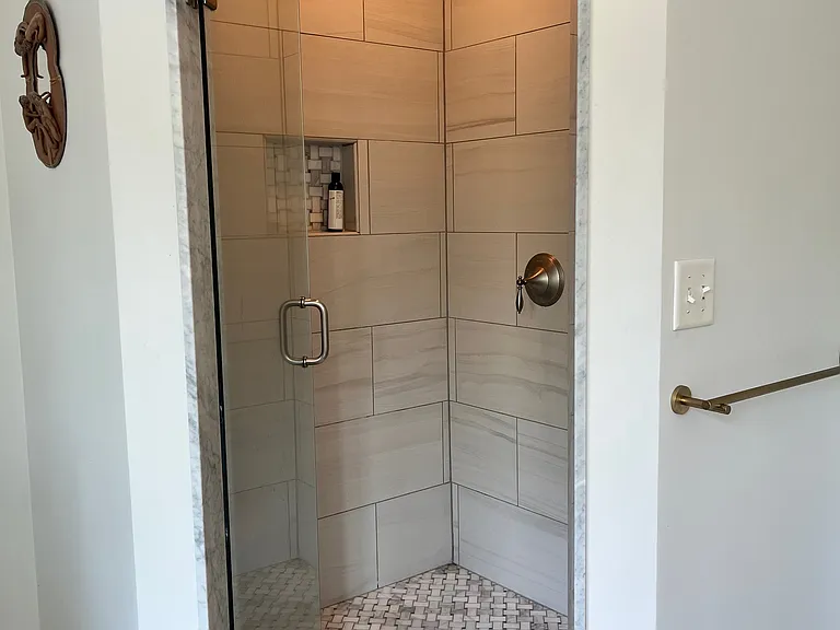 Primary bath marble shower with double shower heads.