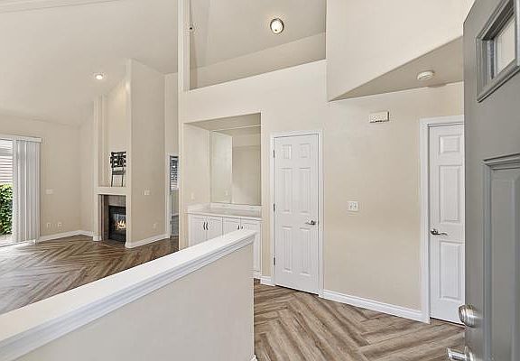Entry way with 2 story high ceiling in living room.