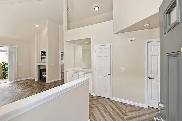 Entry way with 2 story high ceiling in living room.