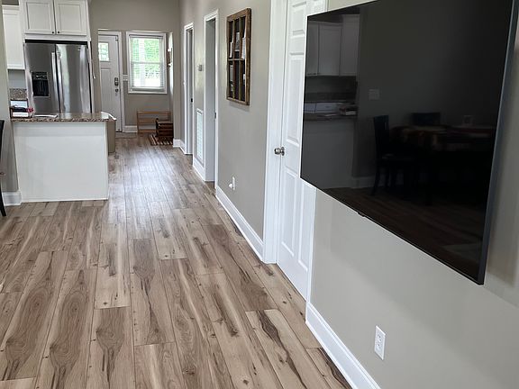View from front door of living area, kitchen, and back door.
