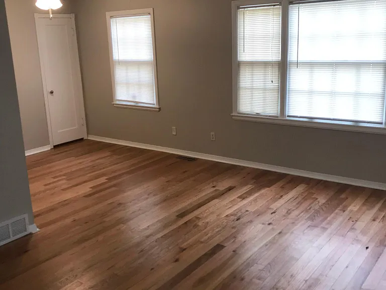 Over sized living room with original hardwoods.