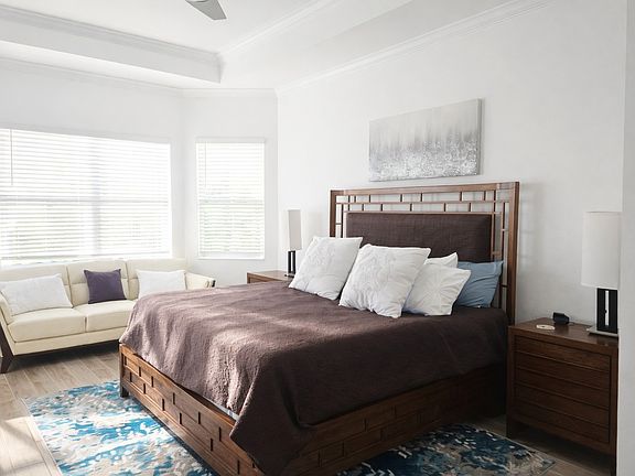 Primary suite with king bed and sofa for reading