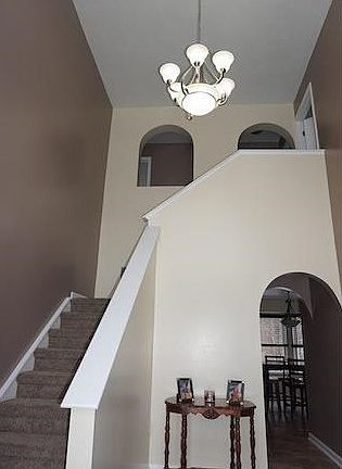 2 Story Foyer freshly painted and updated with new lighting fixtures.