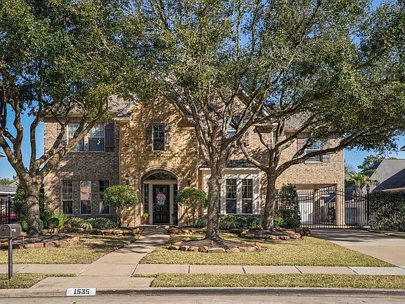 The home is perfectly positioned on a delightful lot with established shade trees, the gated driveway leads to 3-car detached garage with 1 carport and incredibly lovely backyard.