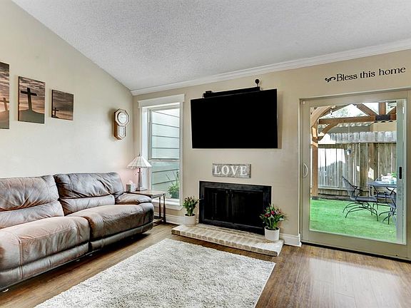 Enjoy the warmth of the fireplace and beauty of the courtyard in the spacious family room.