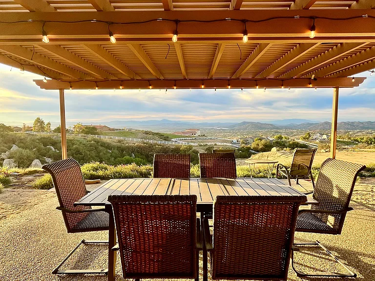 Outdoor dining complete with a propane grill invites indoor/outdoor living