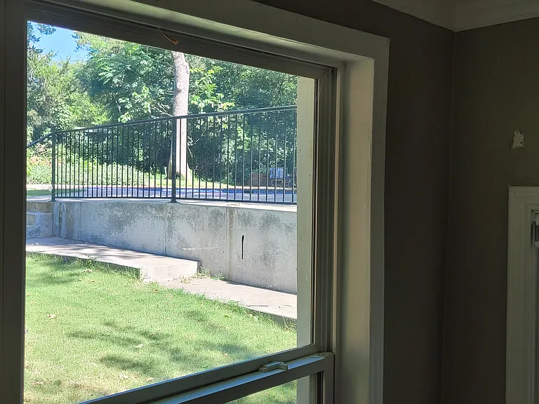 View of the pool out the back windows of back room (Rm#2). Shaded by an old and beautiful crepe myrtle that blooms in summer.