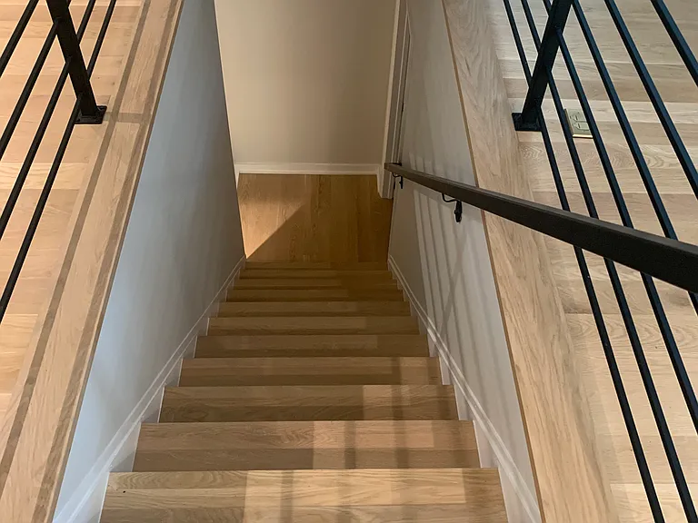 Stairs leading to fully renovated basement. Complete with pocket doors that enable extensive flexibility. Access the brand new bathroom, storage room, and gym and sauna room without disturbing the guest quarters (perfect for au pairs, in-laws, or guests).