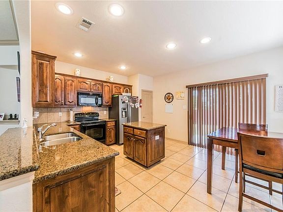Another view of kitchen. New blinds on patio door!