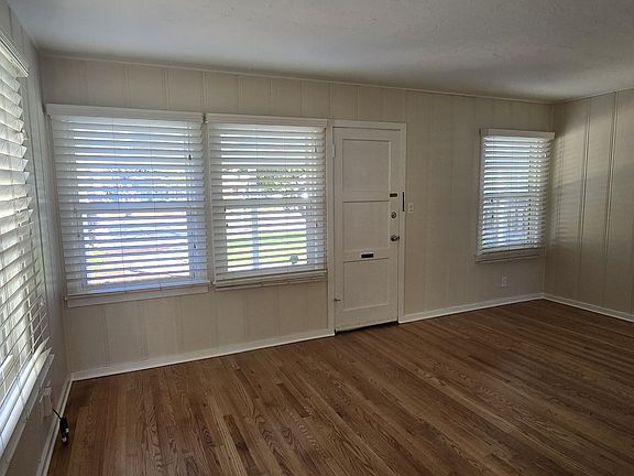 Livingroom with an abundance of natural light. Hardwood floors throughout and wood paneling give charm.