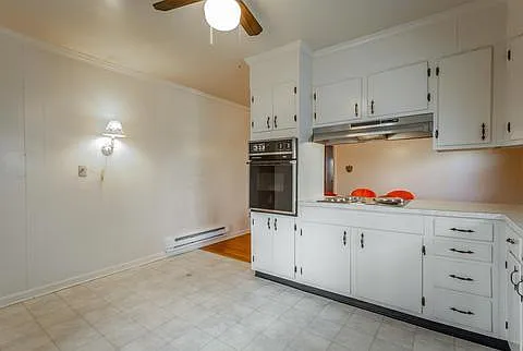 Original kitchen w wall oven, and electric stovetop. Lots of cabinet space, and dining room is right there.