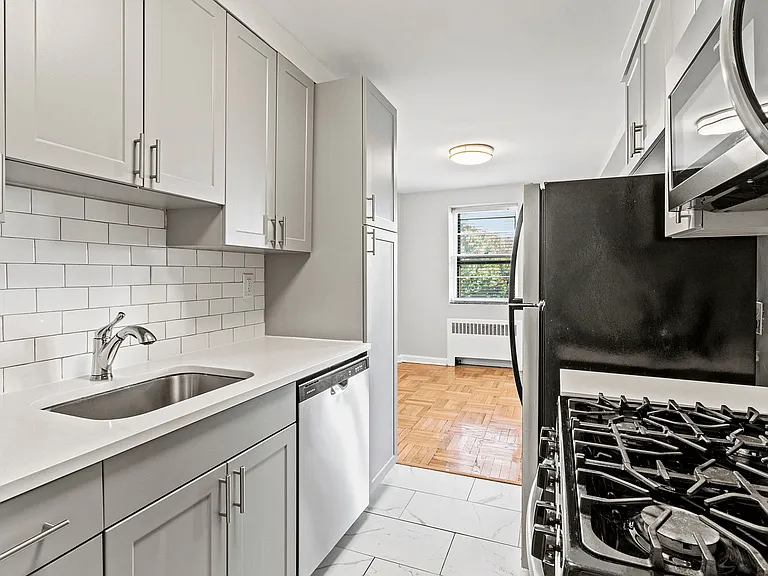 Experience culinary bliss in this chic modern kitchen, bathed in natural light.