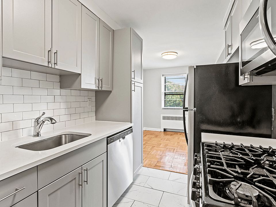 Experience culinary bliss in this chic modern kitchen, bathed in natural light.