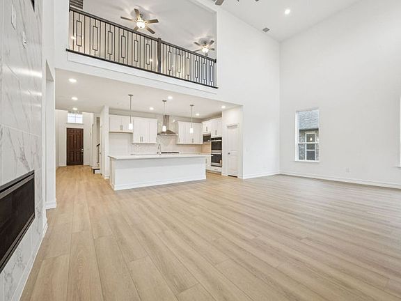 Open concept living area with two-story ceilings photos depict features and options that may not be