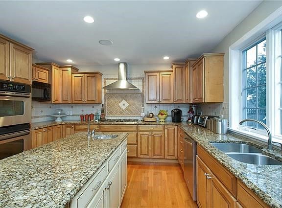 View of kitchen showing double oven and granite counter