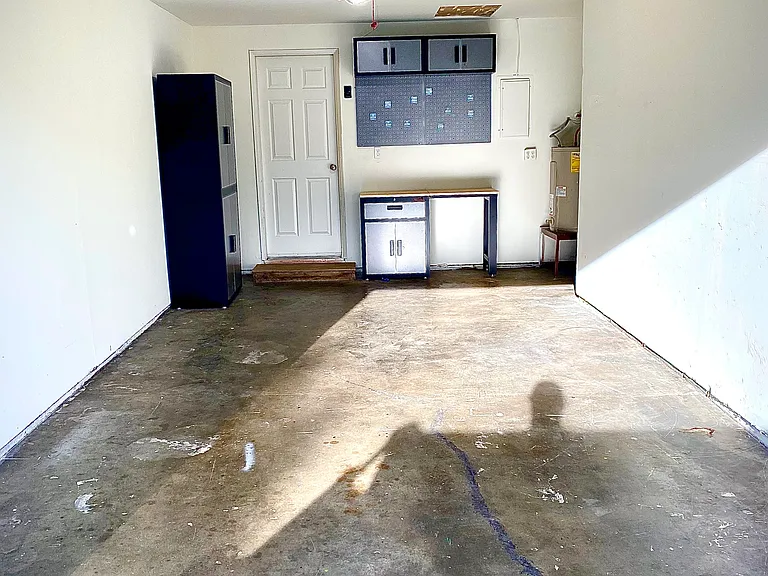 Single car garage with opener, storage cabinets, work bench and direct access into home