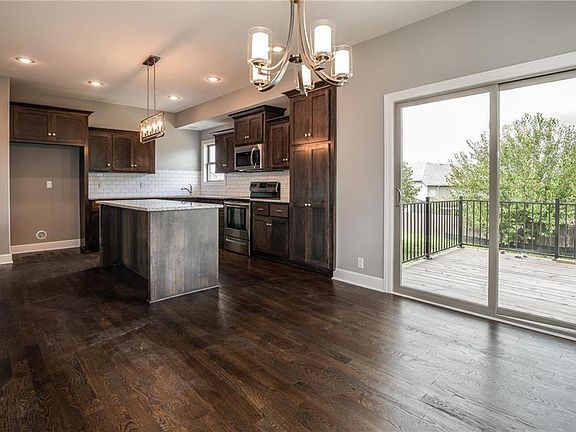 424 Spring Branch, Raymore, MO   The dining room opens to the deck and has great flow to the large kitchen and big island.