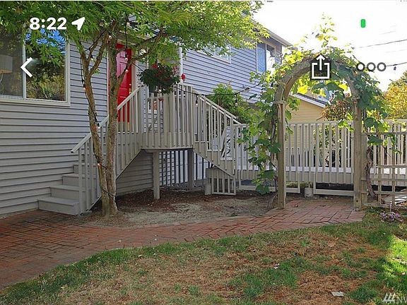 Front of home with grape trellis.