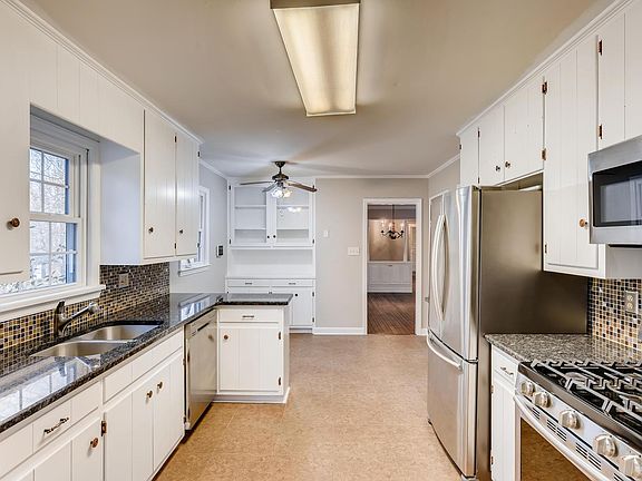 Lots of storage and small peninsula is great for serving. Window at sink.