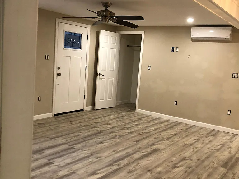 Open concept Kitchen/Dining/Living room with Mini split for heating and cooling and a ceiling fan