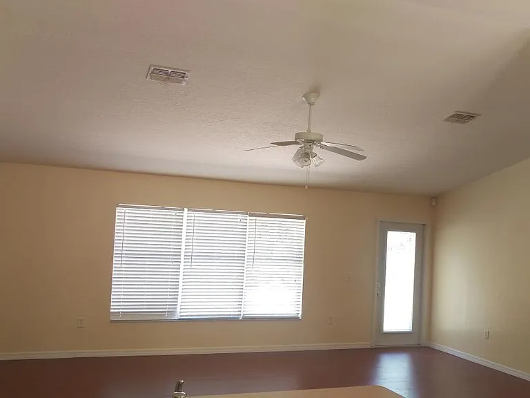 Wood laminate floors High vaulted ceiling living area
