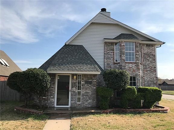Manicured entryway with maintained flower beds.
