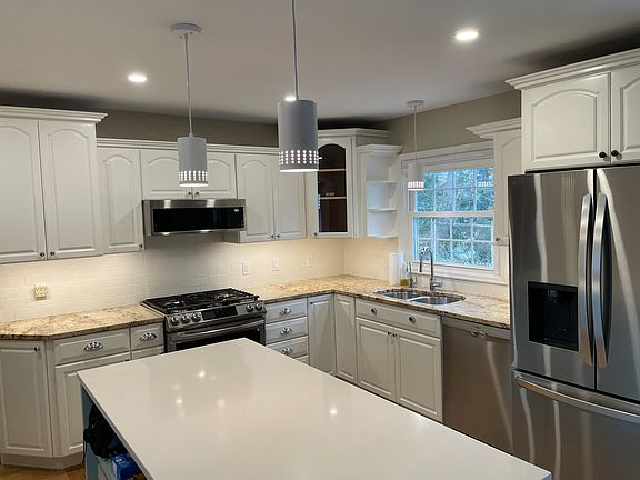 Kitchen, new LG refrigerator, Bosch dishwasher, gas stove. Custom island has deep drawers, and a pull out trash and recycling bin.