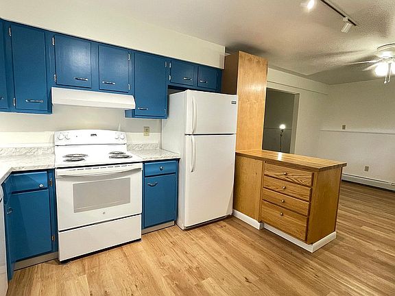 Kitchen w new stove. Island is adjacent to dining area.