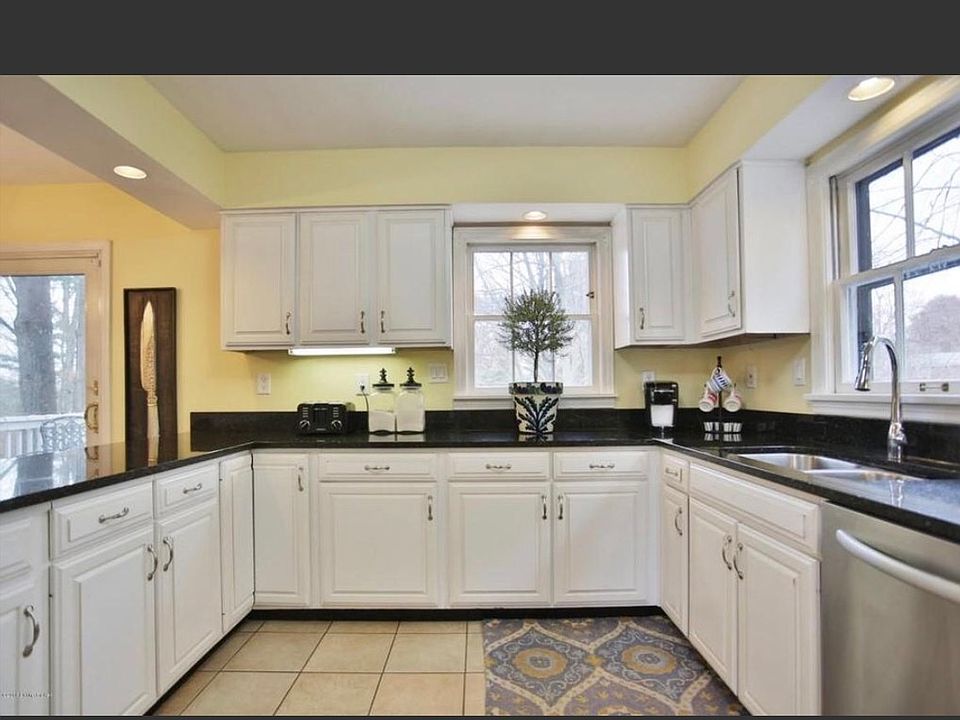 Lovely kitchen with stainless steel appliances and black gra