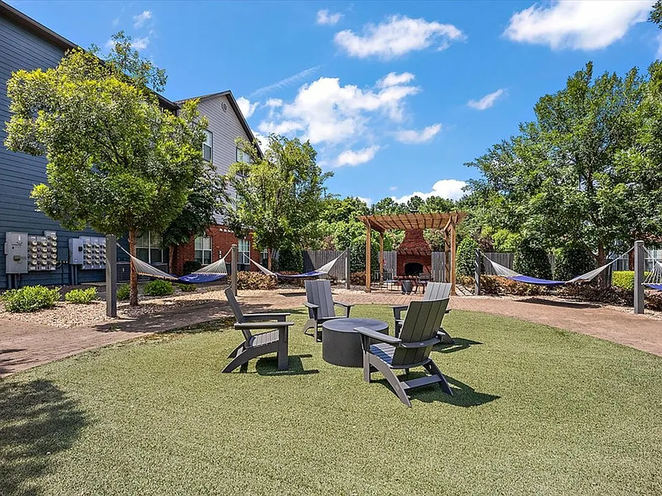 Unwind in the Relaxing Outdoor Lounge with Fire Pit and Hammock Garden at Eagle Flatts Apartments
