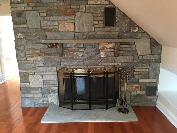 beautiful wood burning fireplace with real stone mantle