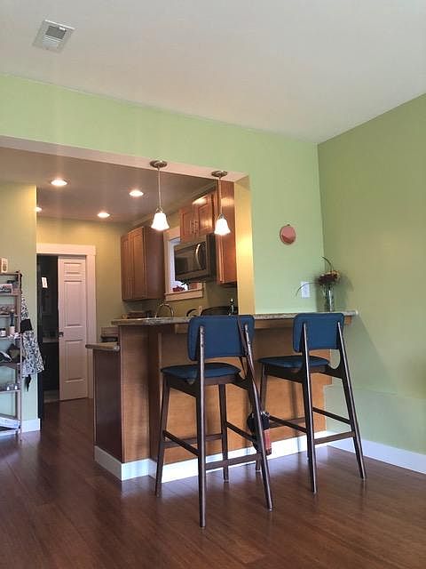 View from the french door entrance, looking into the kitchen. The bathroom is beyond the white door.