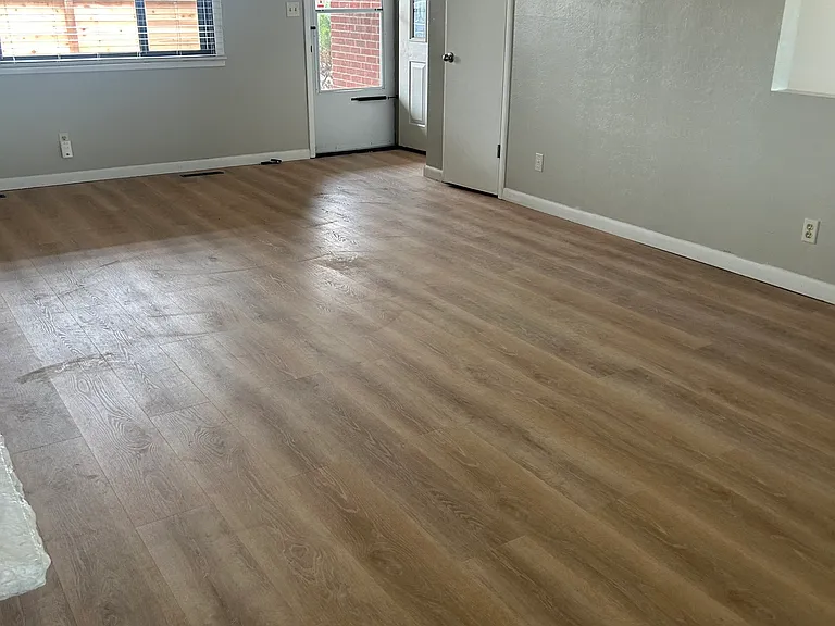 Family Room-looking at front door, coat closet. Also large window like you see in front on opposite west wall(where picture is taken) and back door to balcony.