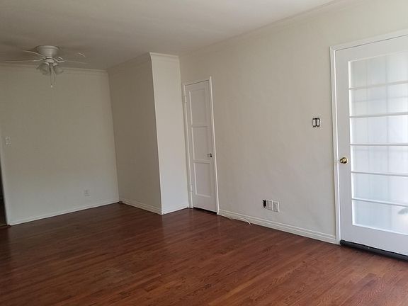 front living area showing front door, entry closet and ceiling fan