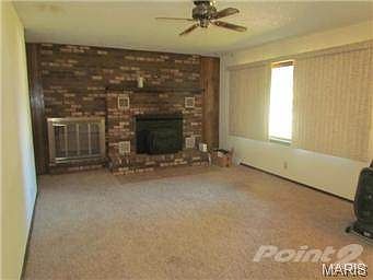 Main floor living room with wood fireplace insert