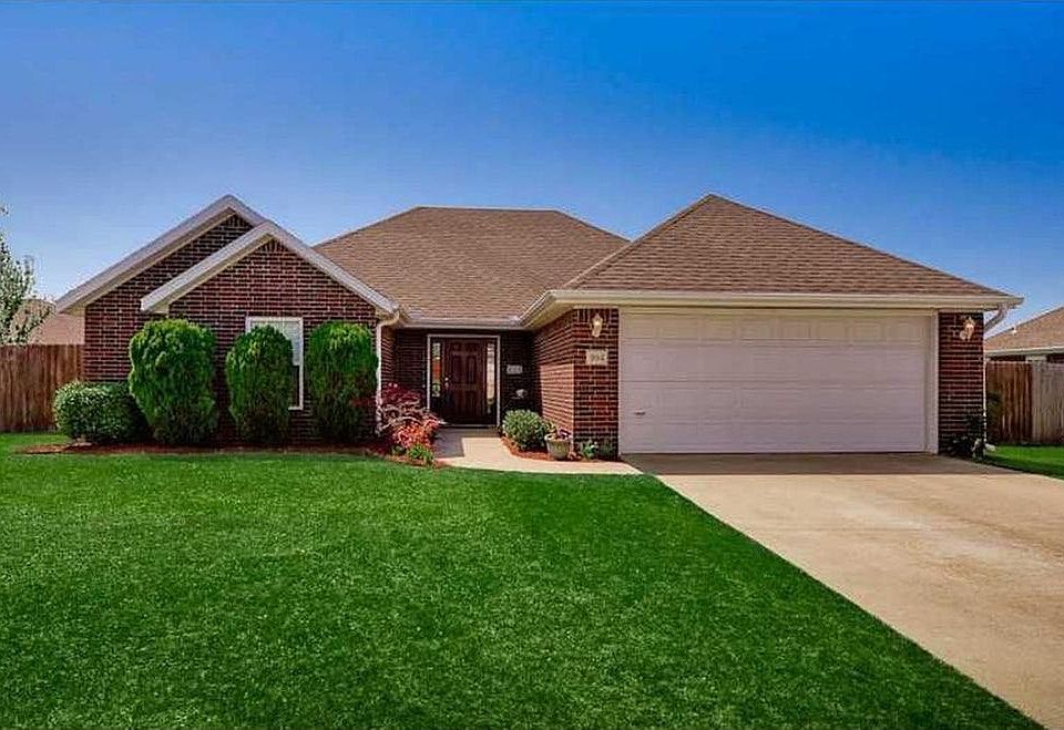 Brick Exterior & 2-Car Garage. Landscaping has been updated since photographed.
