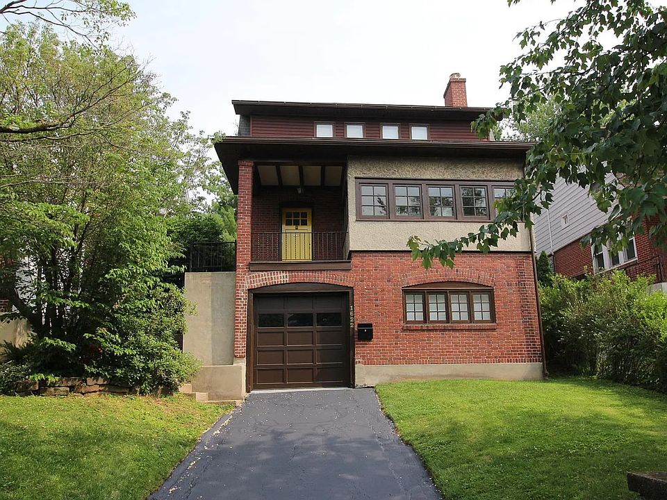 Front entrance, includes balcony. Lower level includes entrance to garage + driveway parking.