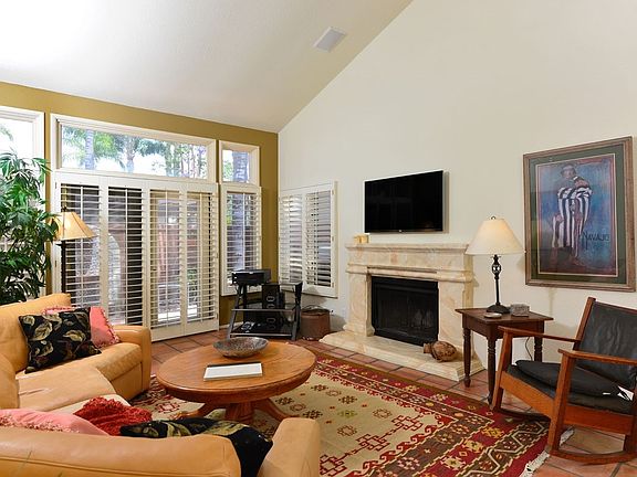 Highlighted by a fireplace and high ceilings, this casual li