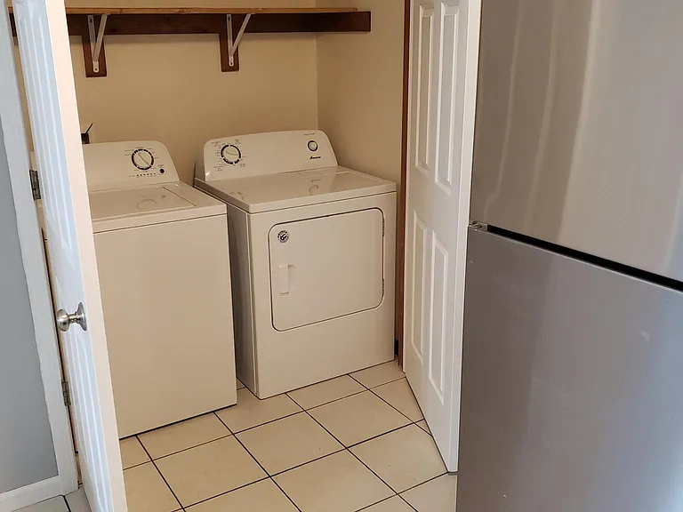 Washer and dryer hook ups in kitchen by garage door entrance
