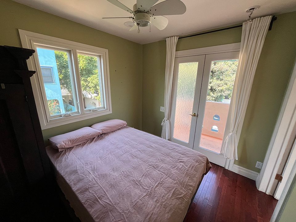 Bedroom with french doors to front balcony.