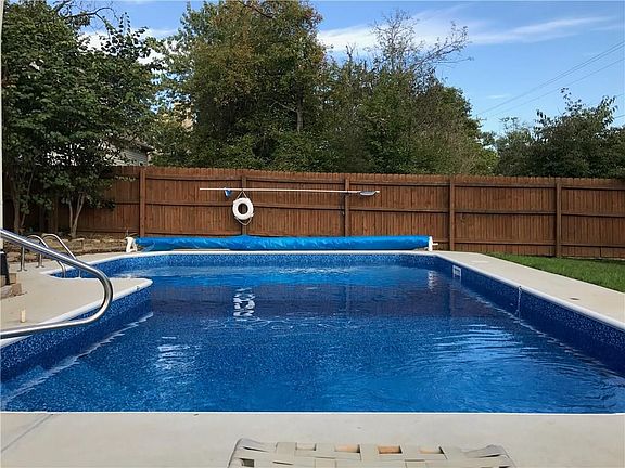 Headed L-shape in-ground pool. Includes winter cover and solar cover.