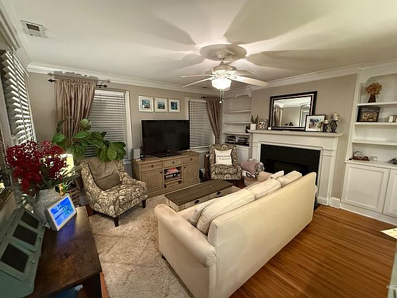 Living Room with Built-in Bookshelves and Ample Storage. Fireplace (not in operation)