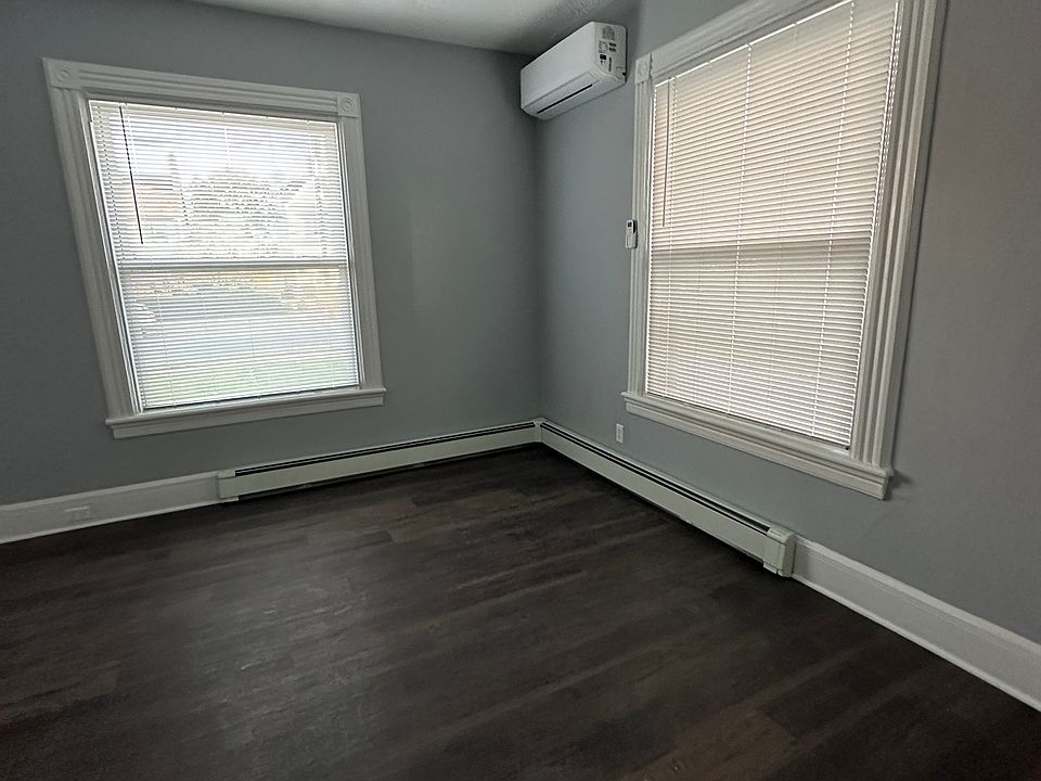 Front room with a new energy efficient mini-split unit that cools & heats in all seasons. New flooring and two windows with blinds.