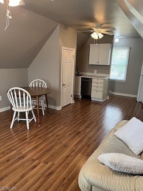 View of living space from opposite side-laminate flooring throughout and ceiling fans
