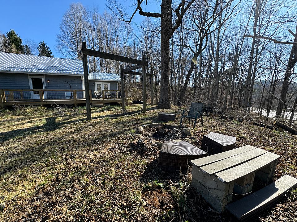 Outside area with fire pit and view of the river.